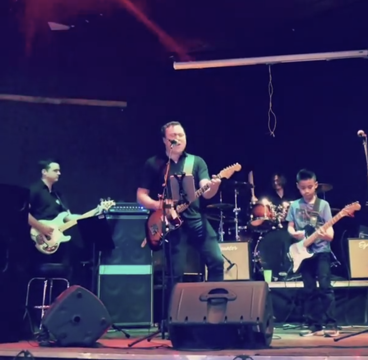 Maverick performing guitar on stage