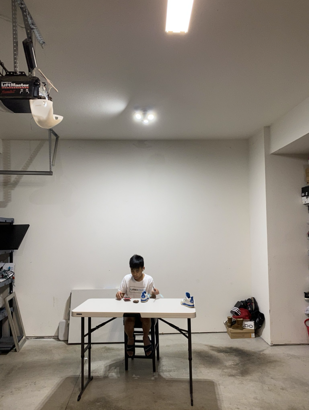 Maverick at 12 painting shoes in the garage